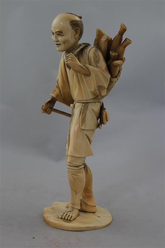 A Japanese sectional ivory figure of a farmer, 21.5cm